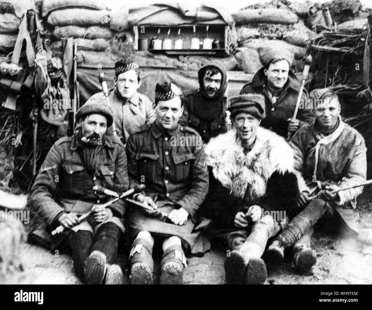 WW1: Northern France: 2nd Battalion Argyll and Sutherland Highlanders, 19th Brigade, 6th and 7th Divisions, Bois Grenier Sector, March - June 1915. A squad of bombers showing some of the original bombs used. Note jam-pot bombs on the shelf in the parapet. One of the men is wearing a Government issue fur jacket. Stock Photo