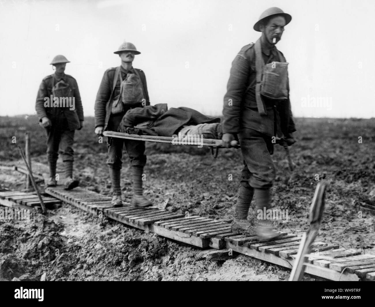 WW1/ France: First Battle of Passchendaele. Two guardsmen bringing in a wounded comrade on a streacher, near Langemarck, October 1917. Stock Photo