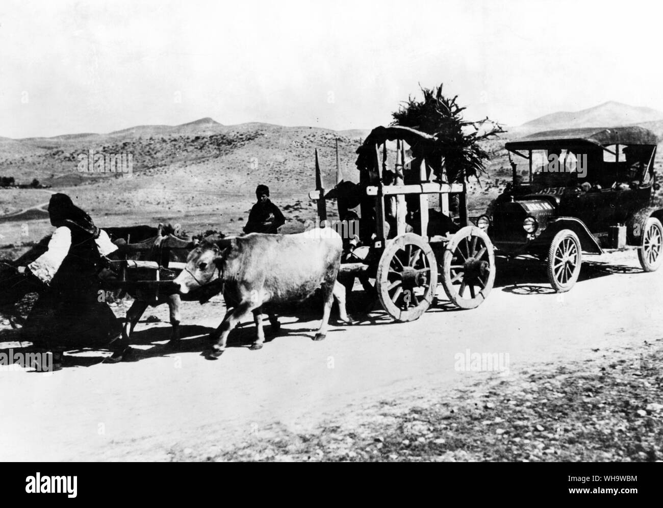 WW1/ The Balkans. Contrasts in Monastir. September 1916. Native people's using carts with a vehicle following behind. Stock Photo