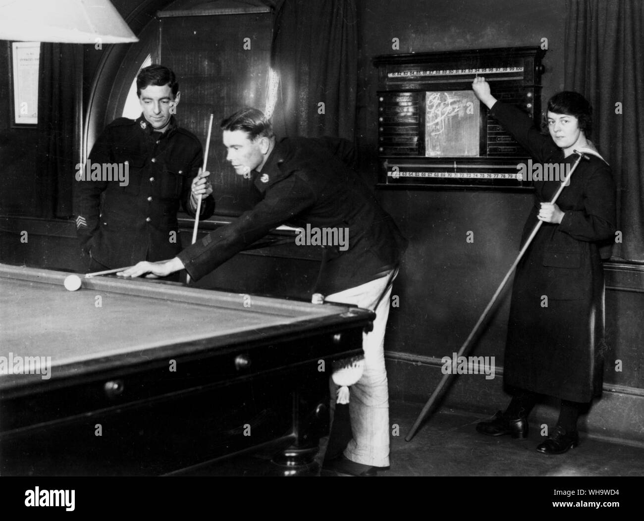 WW1: A rating of the WRNS acting as billiard marker in the men's recreation room, Royal Marine barracks, Chatham, Kent. Stock Photo