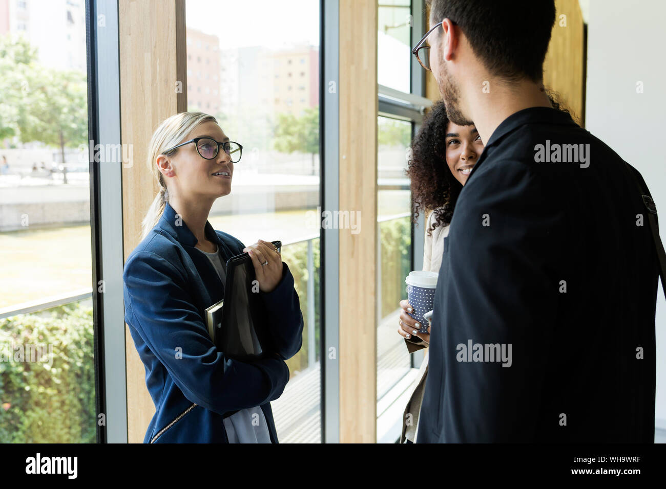 Young business people talking in a hallway Stock Photo