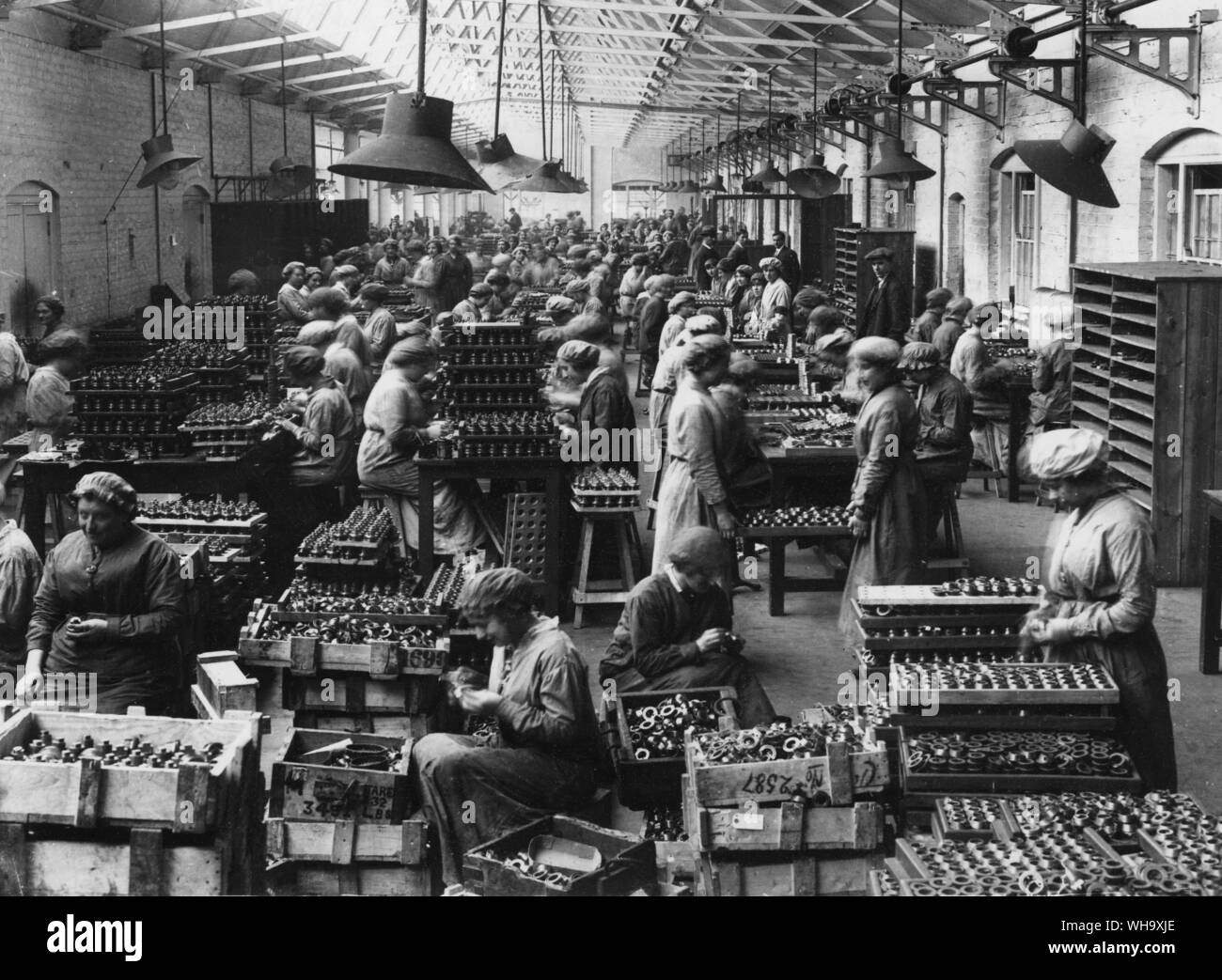 WW1: Arranging the fuse heads in one of England's great gun factories. Stock Photo