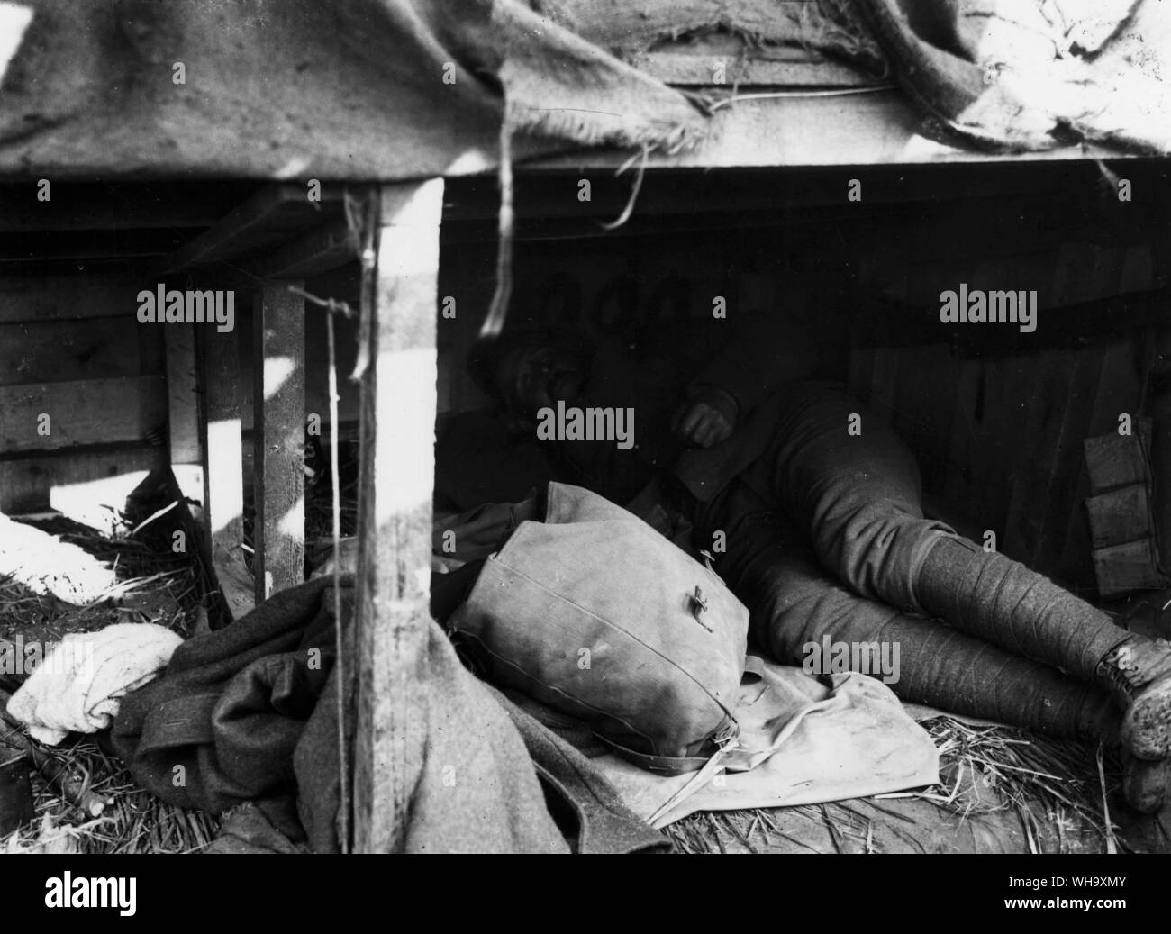 WW1: Dug-out in a trench, 1915. A soldier rests. Stock Photo