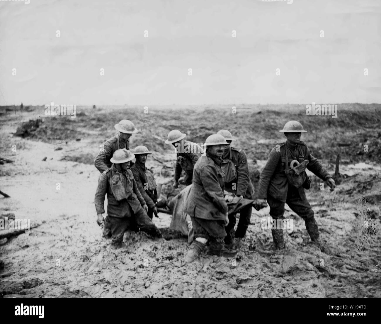 WW1: The common enemy on the Western Front was mud. These stretcher bearers are bringing in a wounded soldier. The mud sometimes reaches their knees. Stock Photo
