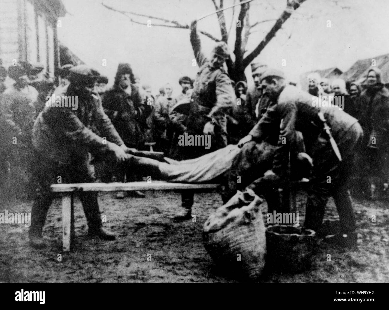 WW2: Russia/ Nazi invaders lashing peasants. Stock Photo