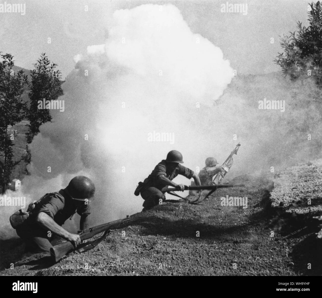 WW2: US Rangers hold a hill post overlooking Naples Plain, Italy. A Ranger patrol advancing up hillside under cover of smoke (undated). Stock Photo