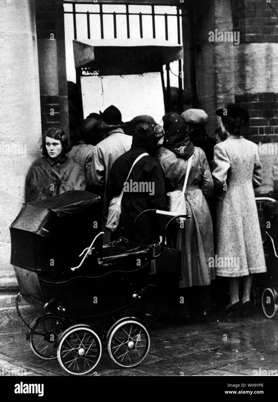 WW2: Anxious relatives read the list of survivors of HMS Royal Oak. Sept. 1939. Stock Photo