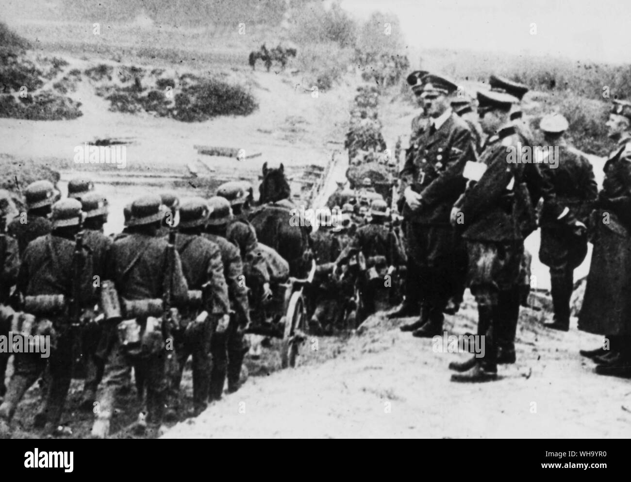 WW2: Hitler and other high German officers watch the long lines of Nazi soldiers marching through the mud of Poland after Germany attacked Poland in the morning hours of 1st September 1939. Two days later England and France, to fulfill their pledge of assistance to Poland, declared war against the Nazi state and the European conflict was under way. Stock Photo