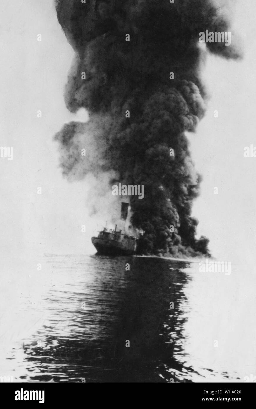 WW1: Enemy oil tanker shot by German U-boat and on fire. 1917. Stock Photo