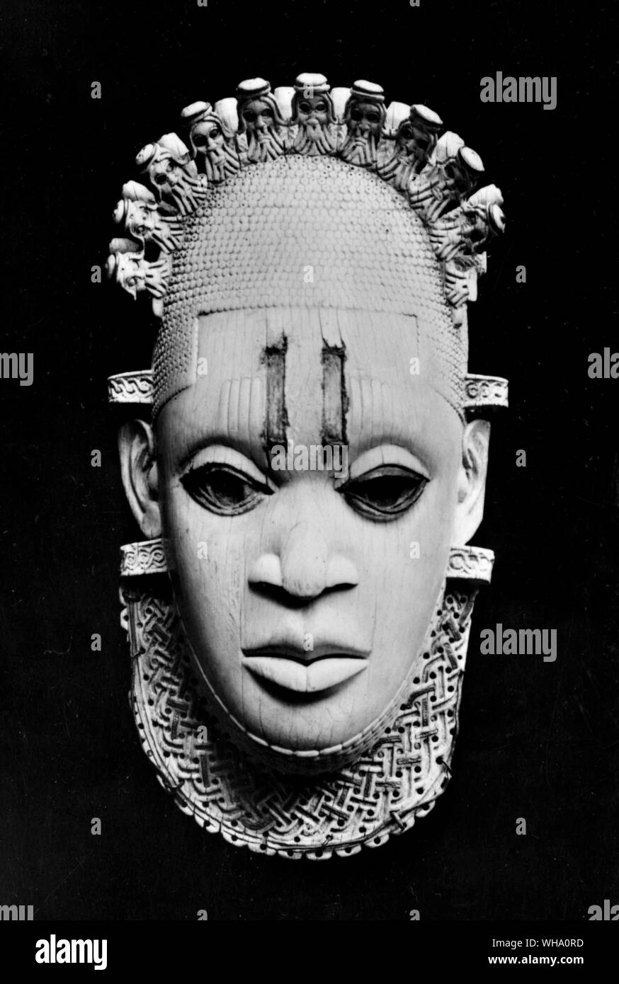 Ivory pendant mask, probably representing an Oba (King) of Benin with a Tiara of miniature heads of Portuguese. From Benin, Southern Nigeria, c. 16th century. Stock Photo