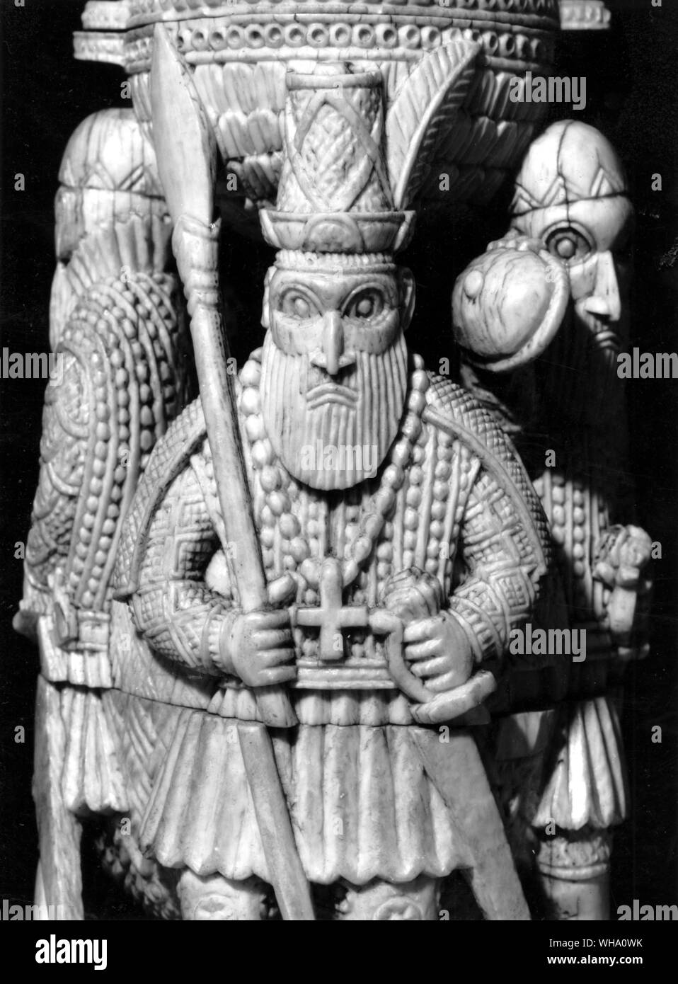 Grim Portuguese adventurers, grasping swords and spears, carved in ivory by a native of Benin Stock Photo