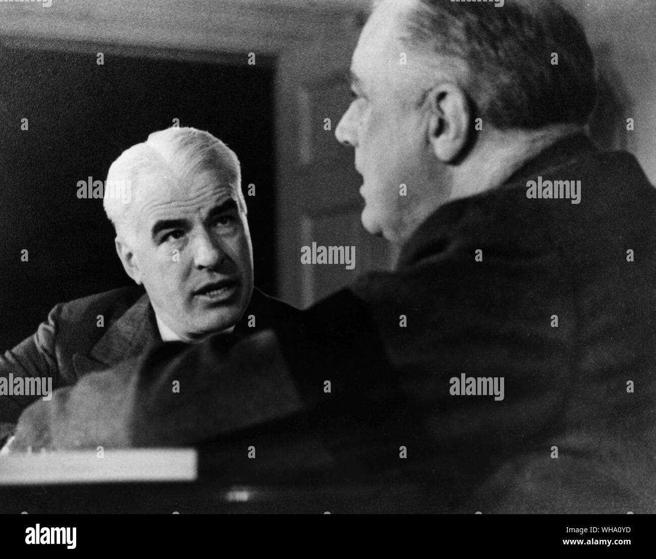 WW2: Edward R Stettinius Jr discusses the 7th Lend-Lease report with President F D Roosevelt in Dec. 1942. Stock Photo