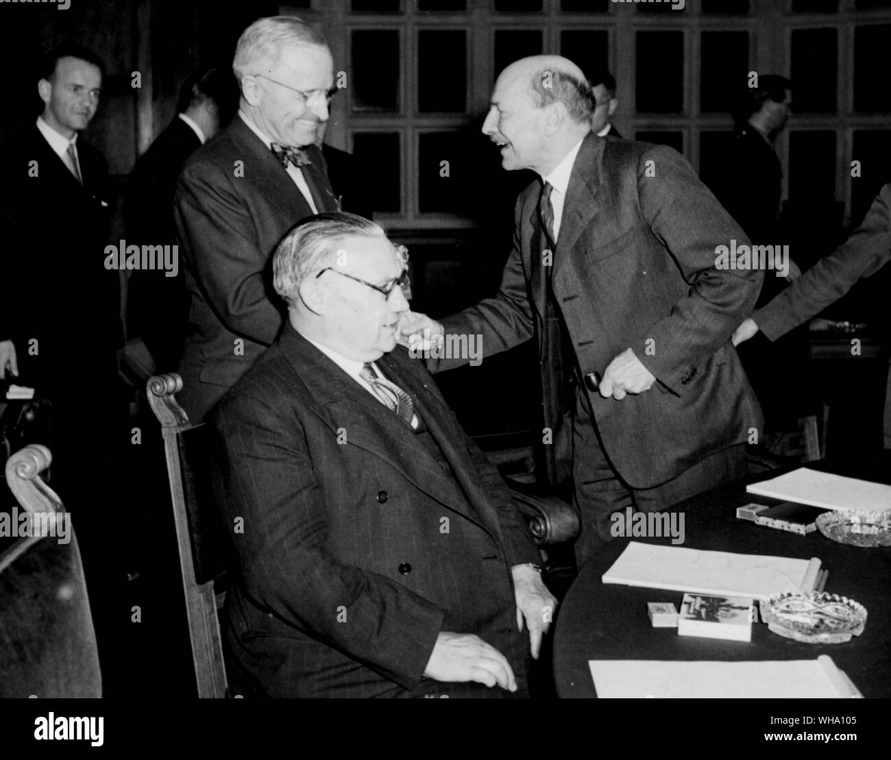 WW2: Potsdam Conference. Truman greets Attlee, with Bevin seated at the Conference table (July 1945). Stock Photo