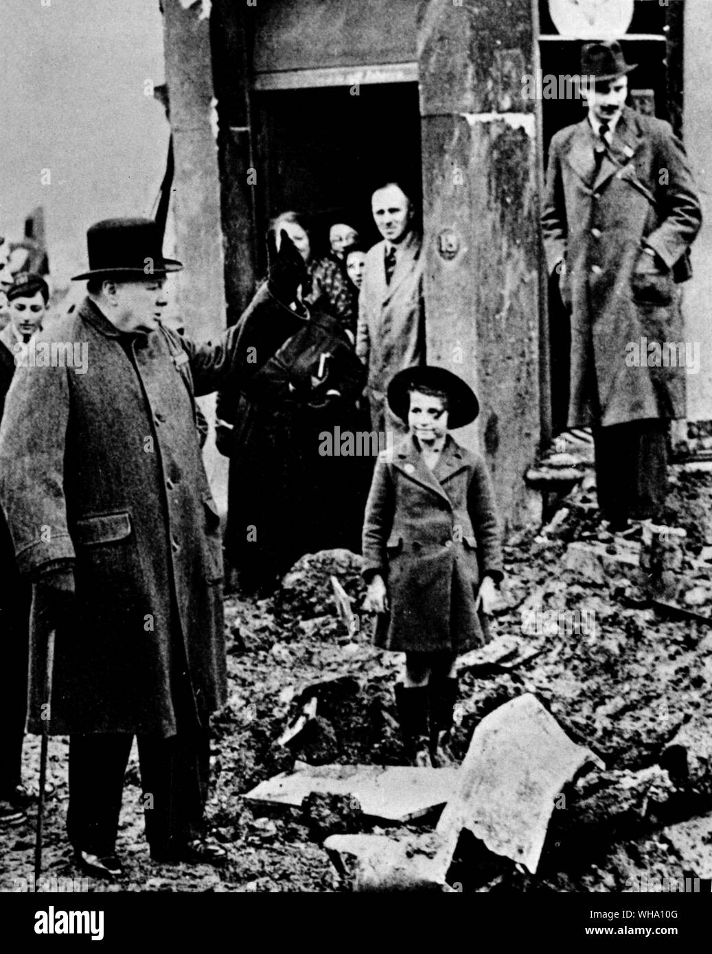 WW2: Winston Churchill in the war damaged streets of England. Stock Photo