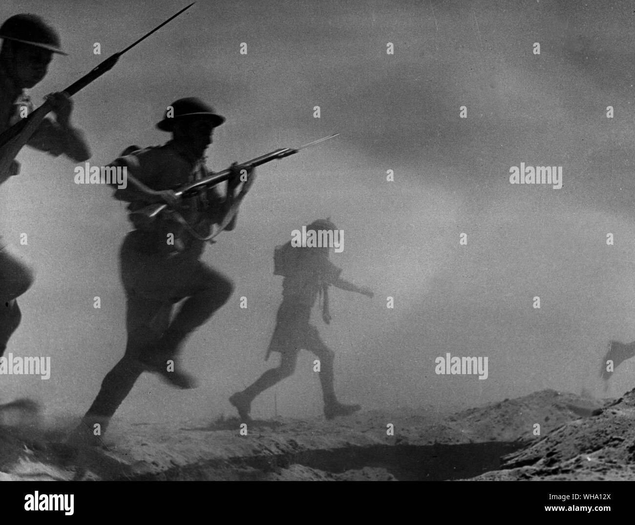 WW2: Alamein. British Infantry close in on an enemy position. 23rd October 1942. (Possibly a fake shot of our lads or they're running in the opposite direction...) Stock Photo