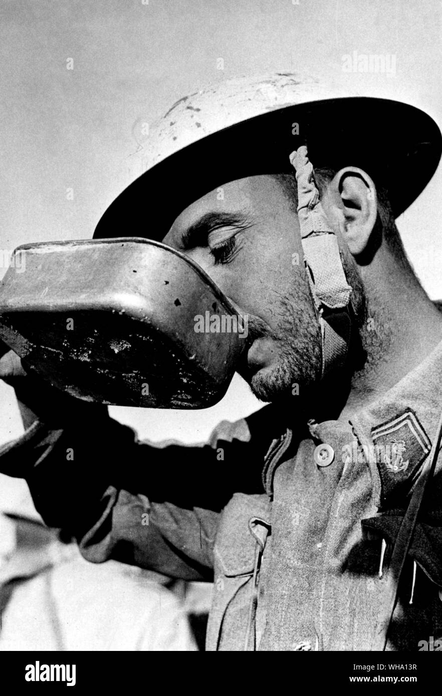 WW2: A free Frenchman drinks after reaching British lines (after evacuation of Bir Hacheim), 13th June 1942. Stock Photo