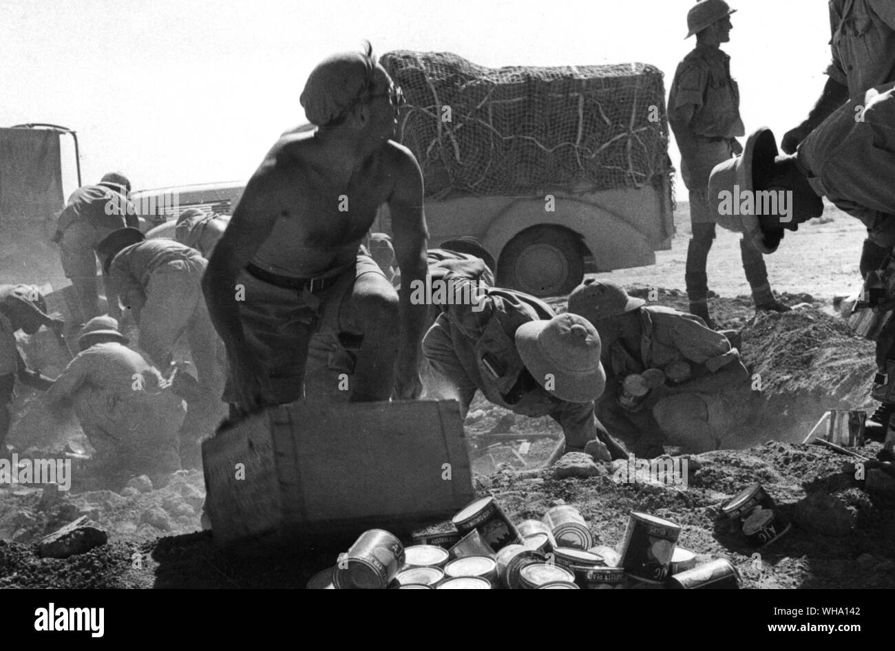 WW2: Troops salvaging food from a dump during retreat (probably 25th June 1942). Stock Photo