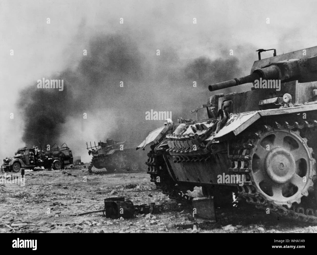 WW2: Tanks, M.T. and armoured vehicles ablaze after S. Africans had captured them. 12th December 1941. Stock Photo