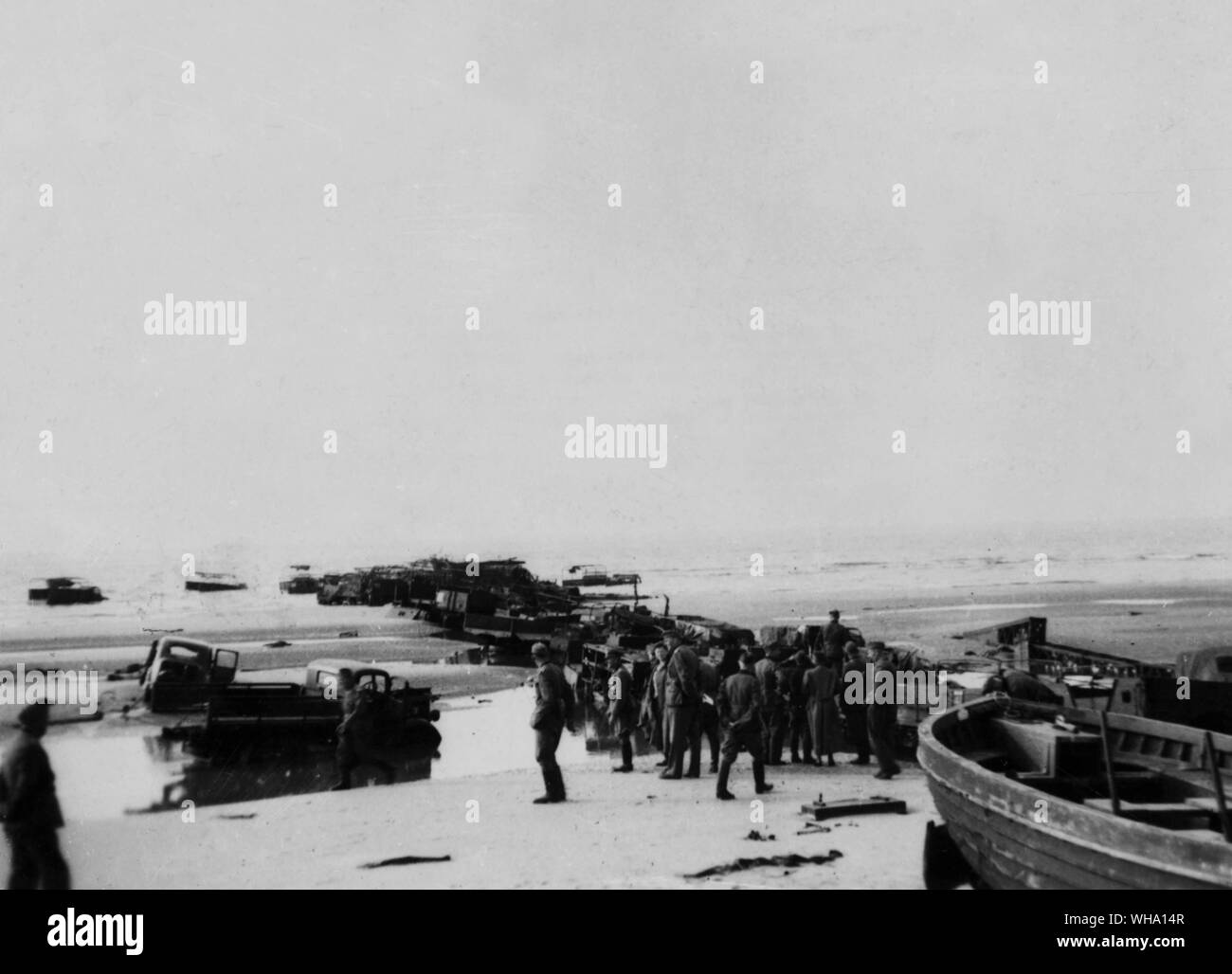 WW2: Pier made by British lorries at Dunkirk. Germans are on the beach after the evacuation. 1940. Stock Photo