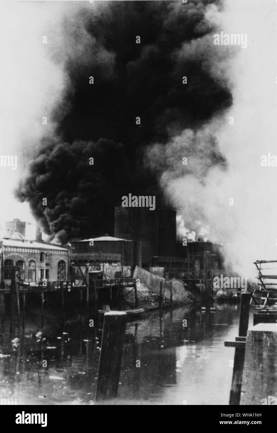 WW2: Explosions of burning gas tanks of Rhenania Ossag refinery dot the water with debris as bombers hit the plant and nearby Hamburg. Results of air attack by 8th Air Force on 6th August 1944. One of seven raids. Stock Photo