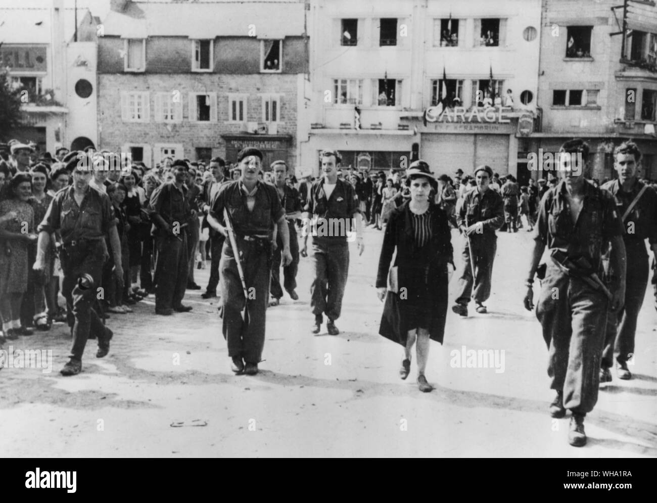 WW2: FFI men march a Frenchwoman accused of being a collaborator with the enemy, through the streets of Guingamp, Brittany. Stock Photo
