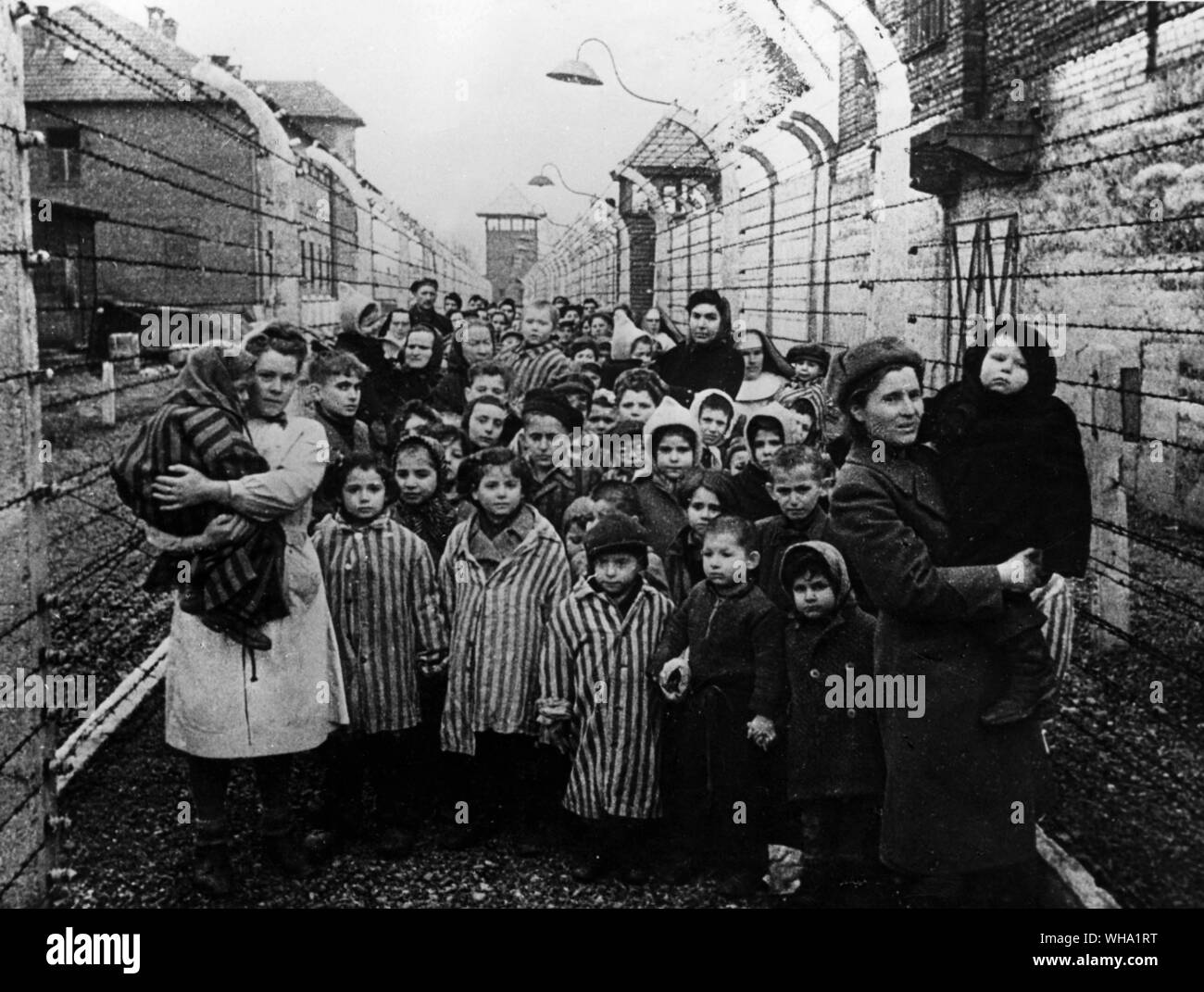 WW2: First hours immediately after the Soviet Army liberated the Oswiecim concentration camp, January 1945. Auschwitz, Poland. Soviet doctors and Red Cross representatives with child-prisoners of the camp. Stock Photo