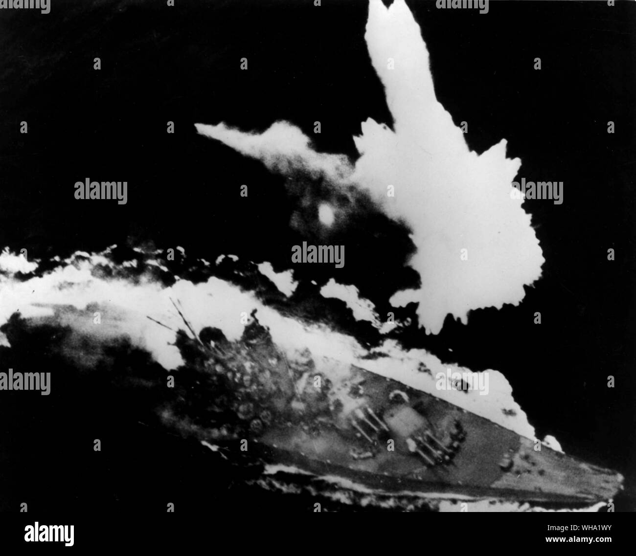 WW2: The navy has just revealed that the Japanese super-battleship, Yamato, used fuel oil extracted from soy-beans in its last engagement. The huge dreadnaught is shown fleeing from aerial bombs and torpedoes of the US Pacific fleet on April 7th, 1945, the day it was sunk. Stock Photo