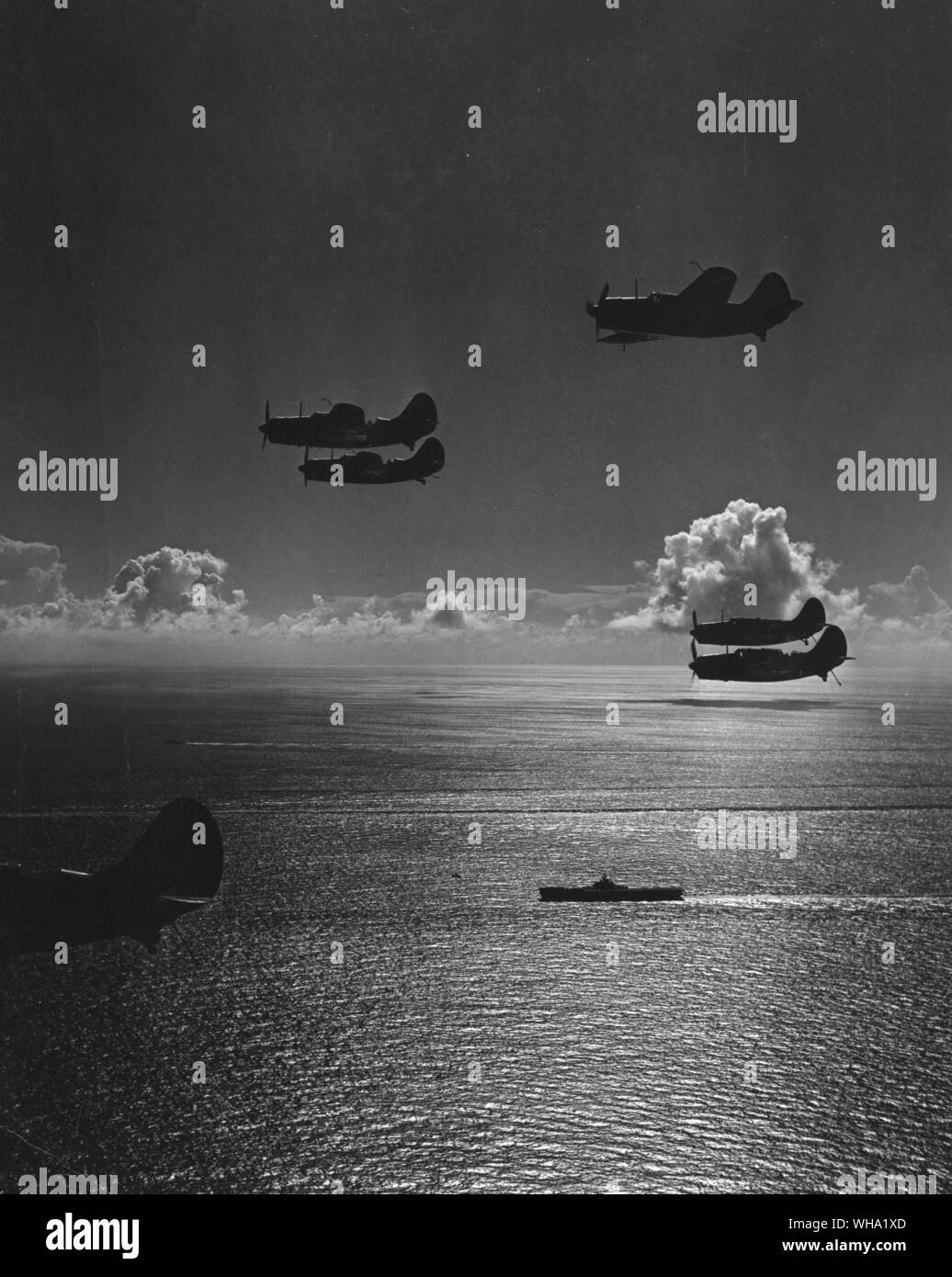 WW2: Silhouettes of SB2C S returning to a carrier of task force 58.1 from a bombing mission over Chicha-Jima in Bonin Islands. 600 miles south of Tokyo. Pacific warfare. Stock Photo