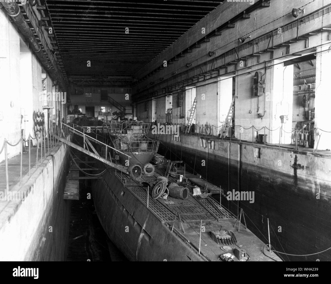 WW2: St. Nazaire, France. German submarine in sub pen at St Nazaire when the Germans surrendered, is back from its 110 day trip in Japanese waters and ready for general overhaul. 13th May 1945. Stock Photo