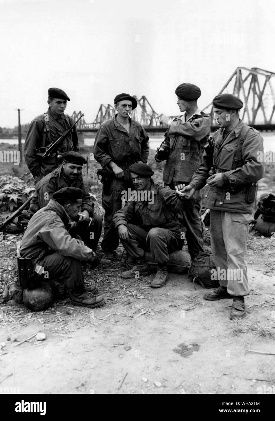 Paratroopers of the French Foreign Legion awaiting transport by the red river bridge near Hanoi in Northern Indo-China, March 1st. 1951 on their way home from patrol. Stock Photo
