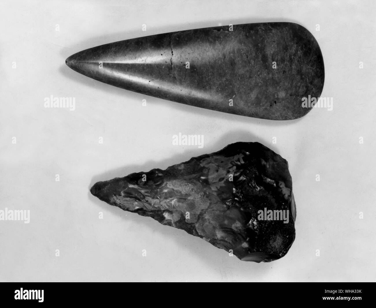 Early Man: Tools. Black St Mary's Axe and polished greenstone axe. Stock Photo