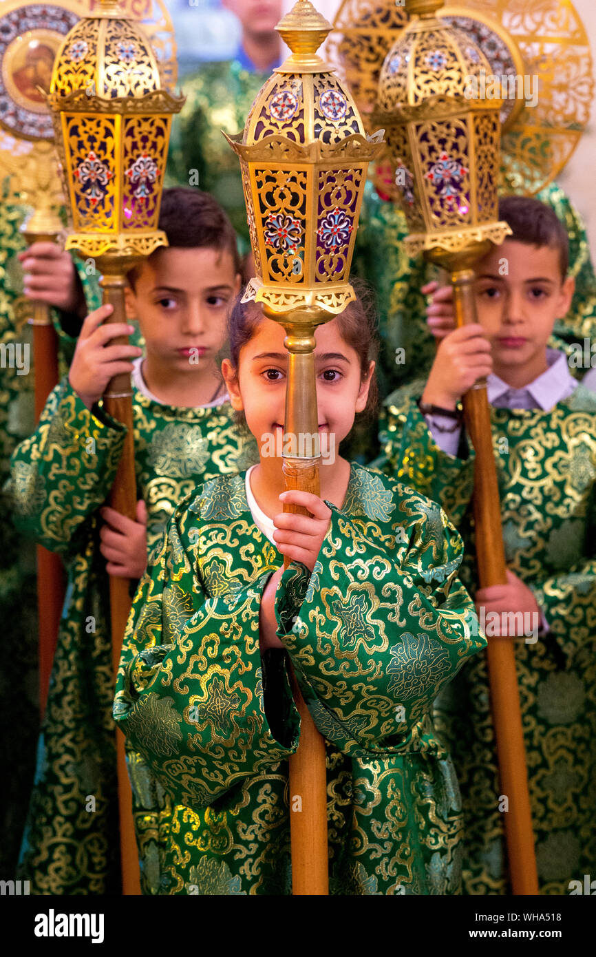 Altar boys and girls at Celebration of the Myrrh bearers' Sunday in the Nazareth Melkite (Greek Catholic) church, Galilee, Israel, Middle East Stock Photo