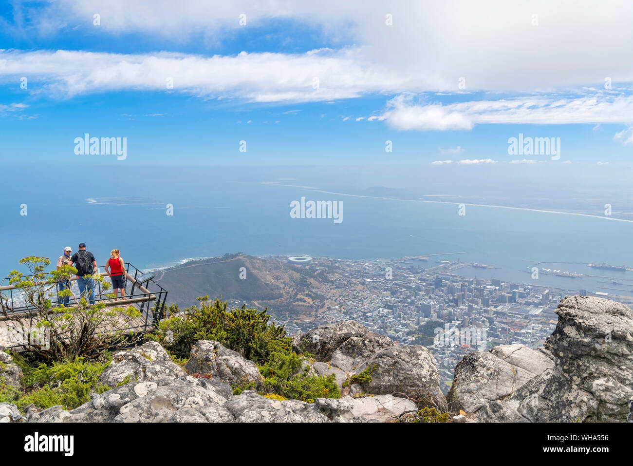 Tourists at a viewpoint on Table Mountain looking west over the city and ocean, Cape Town, Western Cape, South Africa Stock Photo
