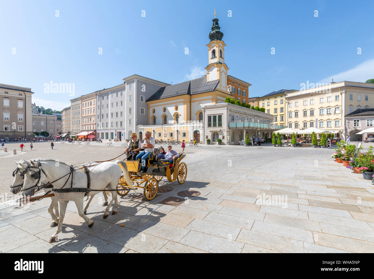 View of St. Michaelskirche and restaurants in Residenzplatz, Salzburg, Austria, Europe Stock Photo