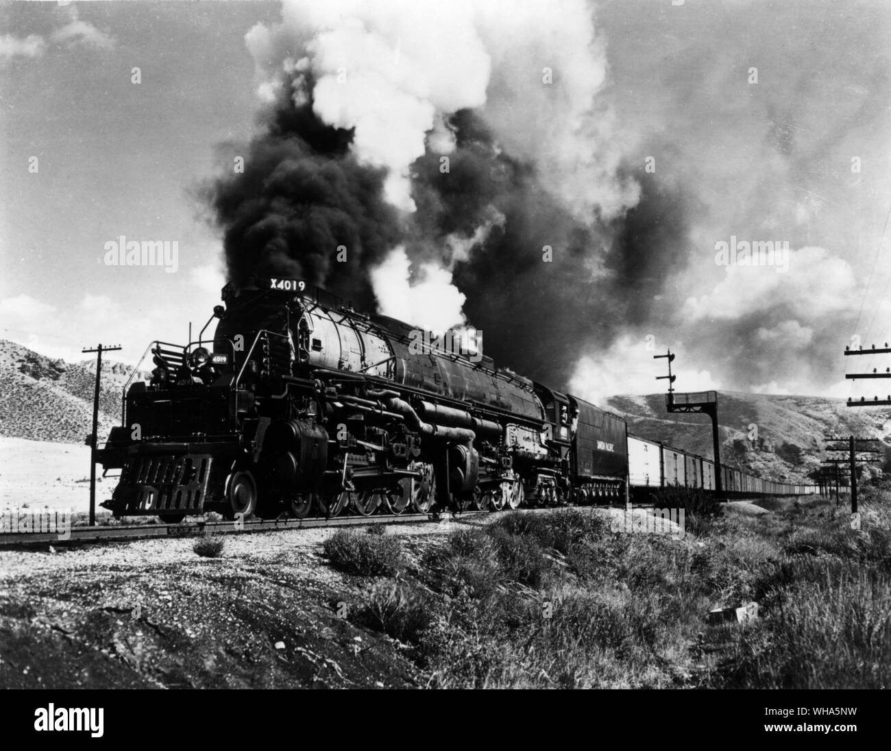 Union Pacific . Class Steam Locomotive. 4-8-8-4 Wheel arrangement . Big Boy Class Designation. First of type built in 1941 for freight service. Locomotive and string of PFE cars in Echo Canyon Utah Stock Photo