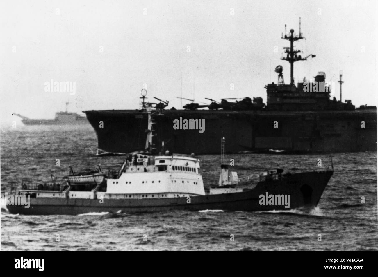 The Soviet Intelligence collection trawler Nakhodka passes amid ships participating in the Nato exercises Strong Express in the Norwegian sea 140 miles off Andoya, Norway.. This trawler passes infront of US helicopter carrier USS Inchon and the tank landing ship USS Fairfax County left and rear.. 22nd September 1972 Stock Photo