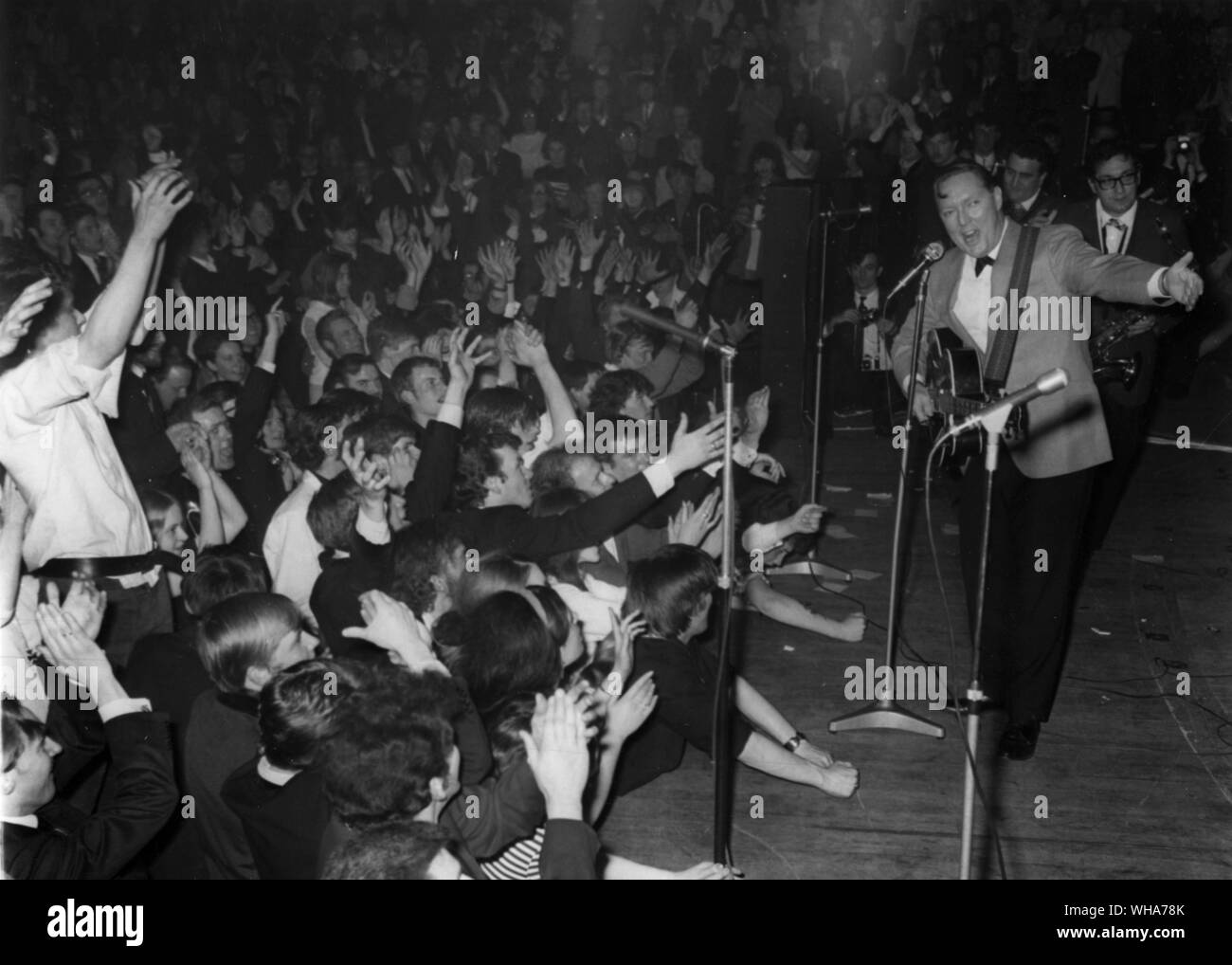 Fans crowd the stage at the Royal Albert Hall May 1st as US rock and roll entertainer Bill Haley introduces his group The Comets at the start of the performance. 1st May 1968 Stock Photo