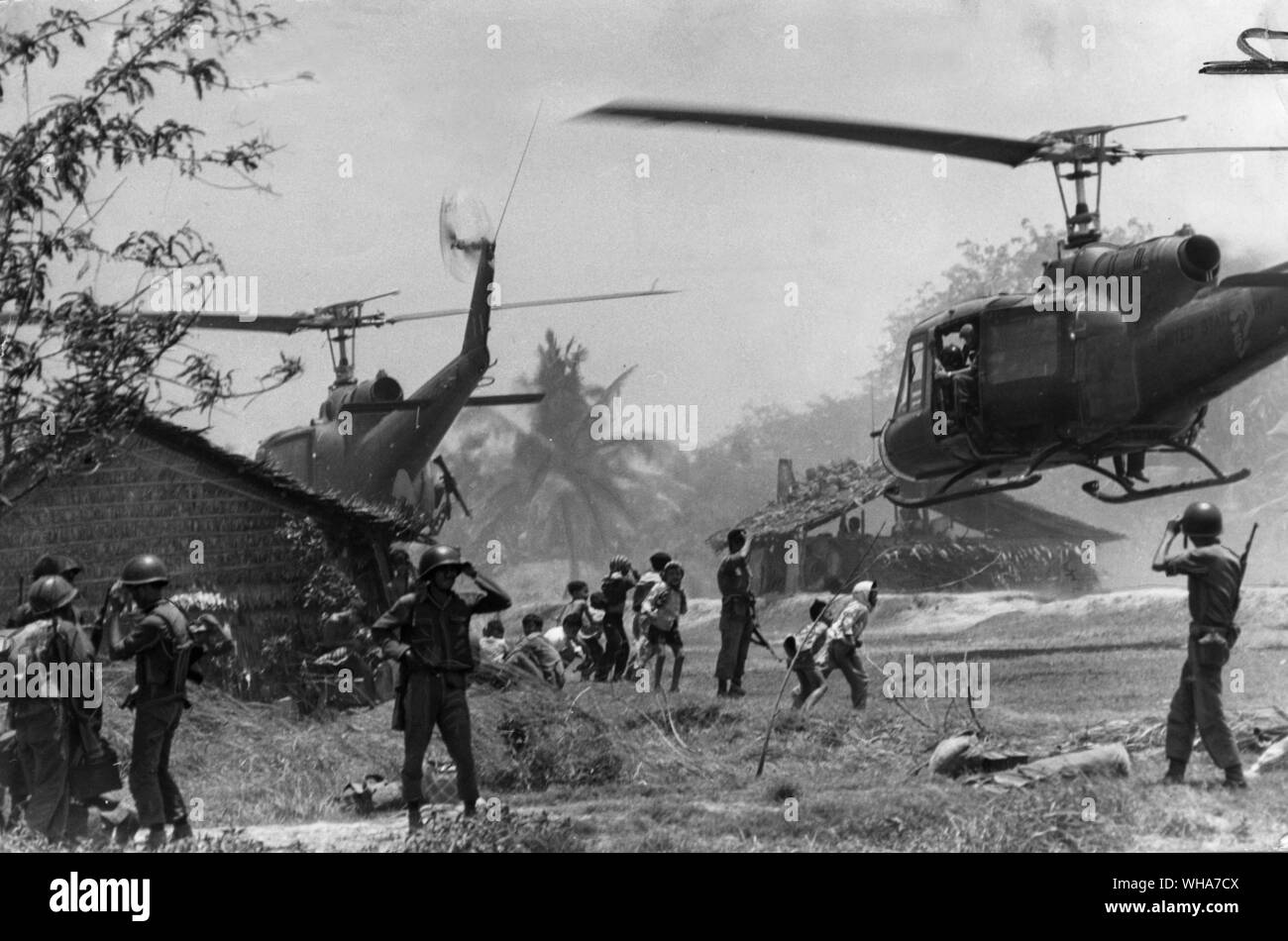 American Marines step up attacks on Viet Cong geurillas at the village of Than-An 10 miles north east of the American air base at Da Nang. Children watch as the helicopters land. Stock Photo