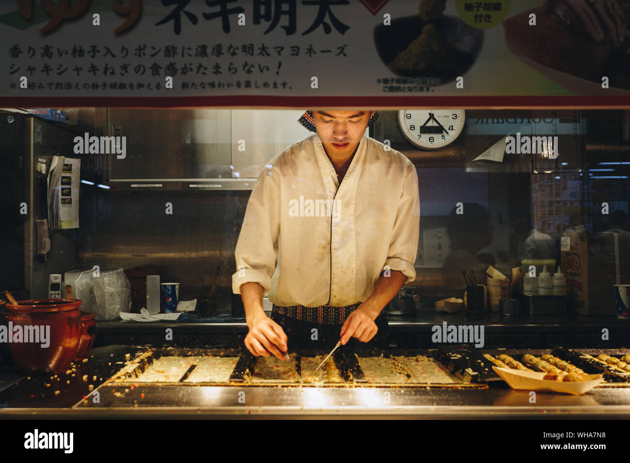 Tokyo, Japan - July 22, 1992 : japanese chef cooking takoyaki in the stall at the train station in Tokyo, Japan. takoyaki is the most popular deliciou Stock Photo