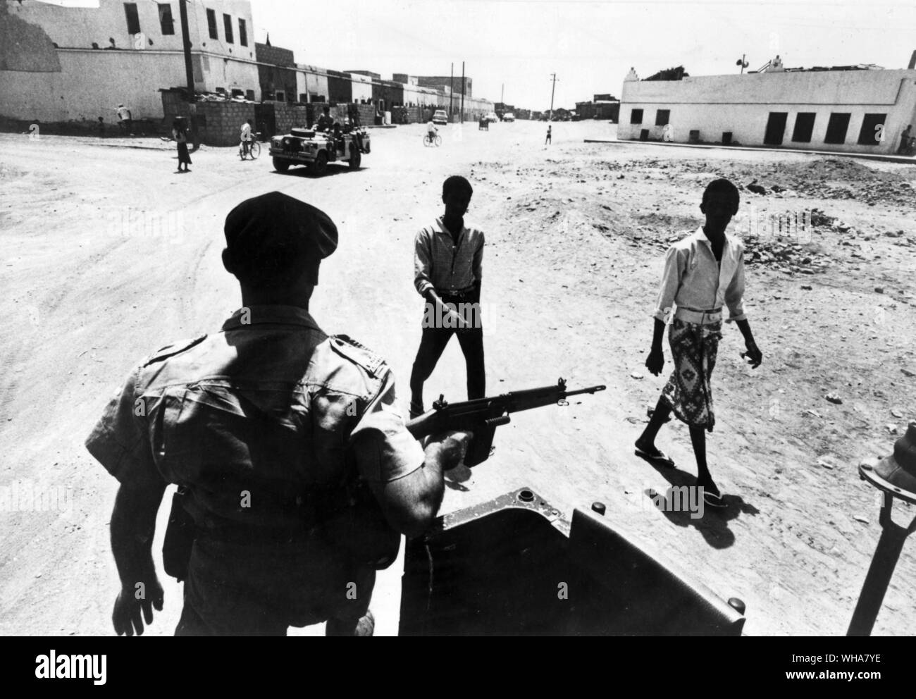 Aden . Only the bomb throwers are happy, near grenade corner, where there is a bomb every 15 minutes, a Royal Anglian Patrol frisks two suspects. 10th March 1967 Stock Photo