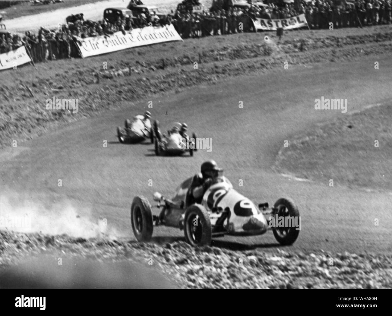 International motor racing at Brands Hatch Headland driving his Cooper 9 skidded and went onto the turf but regained control of the wheel and carried on racing in the open challenge race heat 4 race one.. 13th May 1951 Stock Photo
