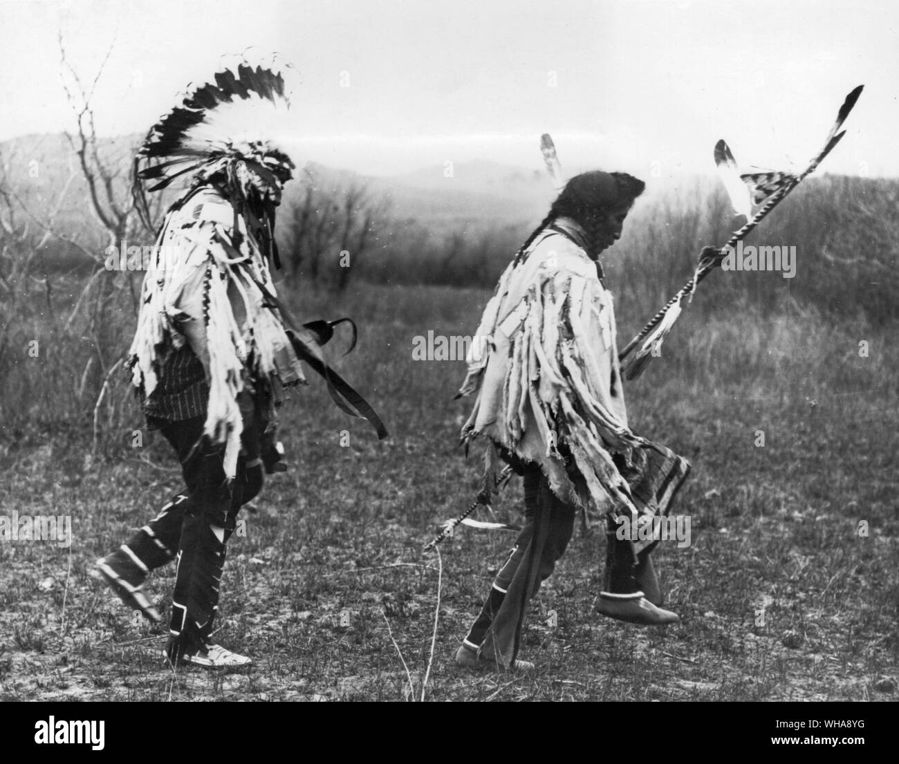 View of Chief Medicine Crow leading the dance. Crow. Montana. Medicine Crow was a warrior from the time he first went on the warpath at the age of fifteen until his last battle in 1877. He attained chieftaincy about 1870 at the age of twenty-two, and from then on he set the pace for aspiring young warriors of his people. Until his death in 1920, at the age of seventy-two, he was a reservation chief, concerned with helping the Crow tribe learn to live in the ways of the white man as soon and as efficiently as possible. He went to see the Great Father in Washington many times on behalf of his Stock Photo