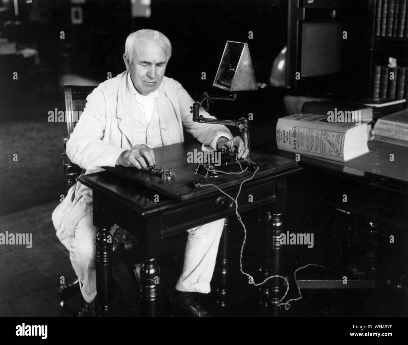 Edison seated at Telegraph key 1920. 28th July 1920. Edison National Historic Site Orange New Jersey. . Edison, Thomas Alva (the Wizard of Menlo Park) US inventor; opened research laboratory in Menlo Park, New Jersey 1876 (moved to West Orange, New Jersey 1887); invented phonograph (1st demonstrated 1877); invented incandescent electric light 1879; invented kinetograph camera and kinetoscope motion-picture viewer (patented 1891)  1847-1931 . . Stock Photo