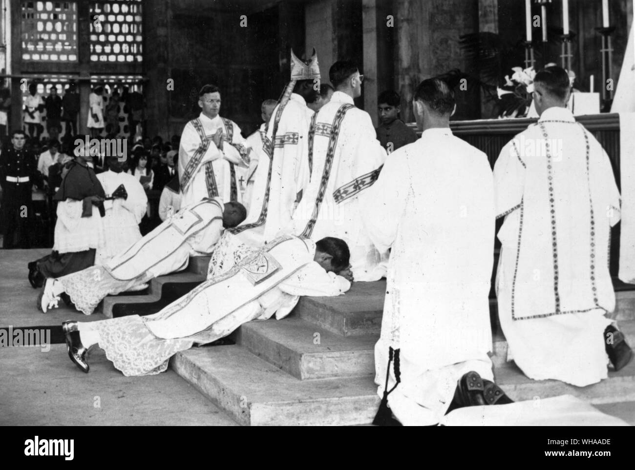 Nairobi. Consecration of two Apostolic Delegates for Africa, ceremony in the unfinished cathedral of the Holy Family on 31st December 1961. The Archbishops who were consecrated were their Excellencies the Most Reverend Guido Del Mestri and the Most Reverend Felix Pirozzi, Apostolic Delegates respectively in Nairobi (Kenya) and Tananarive (Madagascar ). The consecrator was his Eminence Cardinal Laurean Rugambwa, Bishop of Bukoba. Co-consecrators were the Most Reverend Ireneus Dud, Vicar Apostolic of Wau, Sudan. Photograph shows Cardinal Rugambwa kneeling at the altar during the recitation of Stock Photo