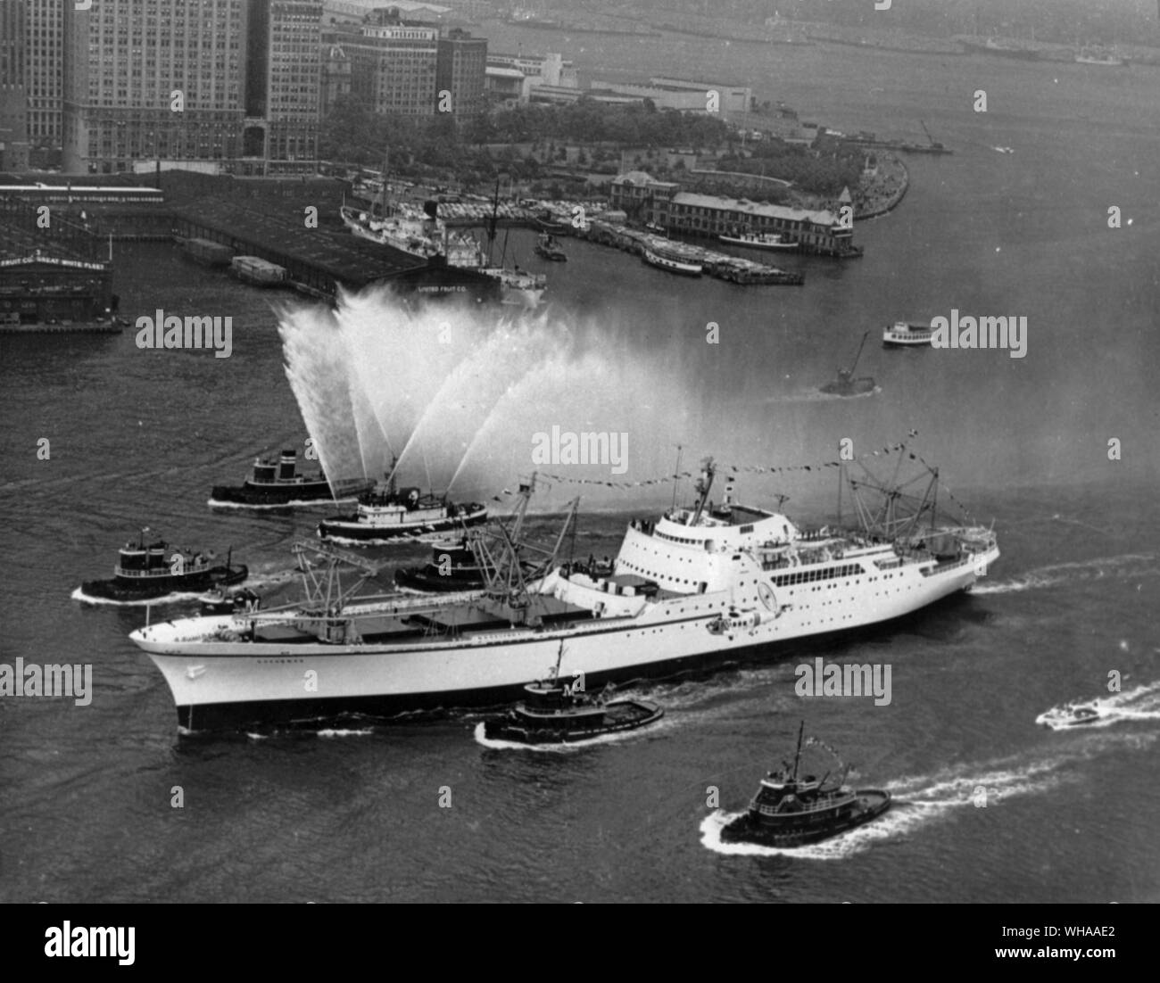 Enthusiastic New York reception for nuclear ship Savannah. Escorted by a flotilla of tugs, small craft and fireboats spouting their traditional greetings, the nuclear ship Savannah moves up the Hudson River in the Port of New York.. Stock Photo