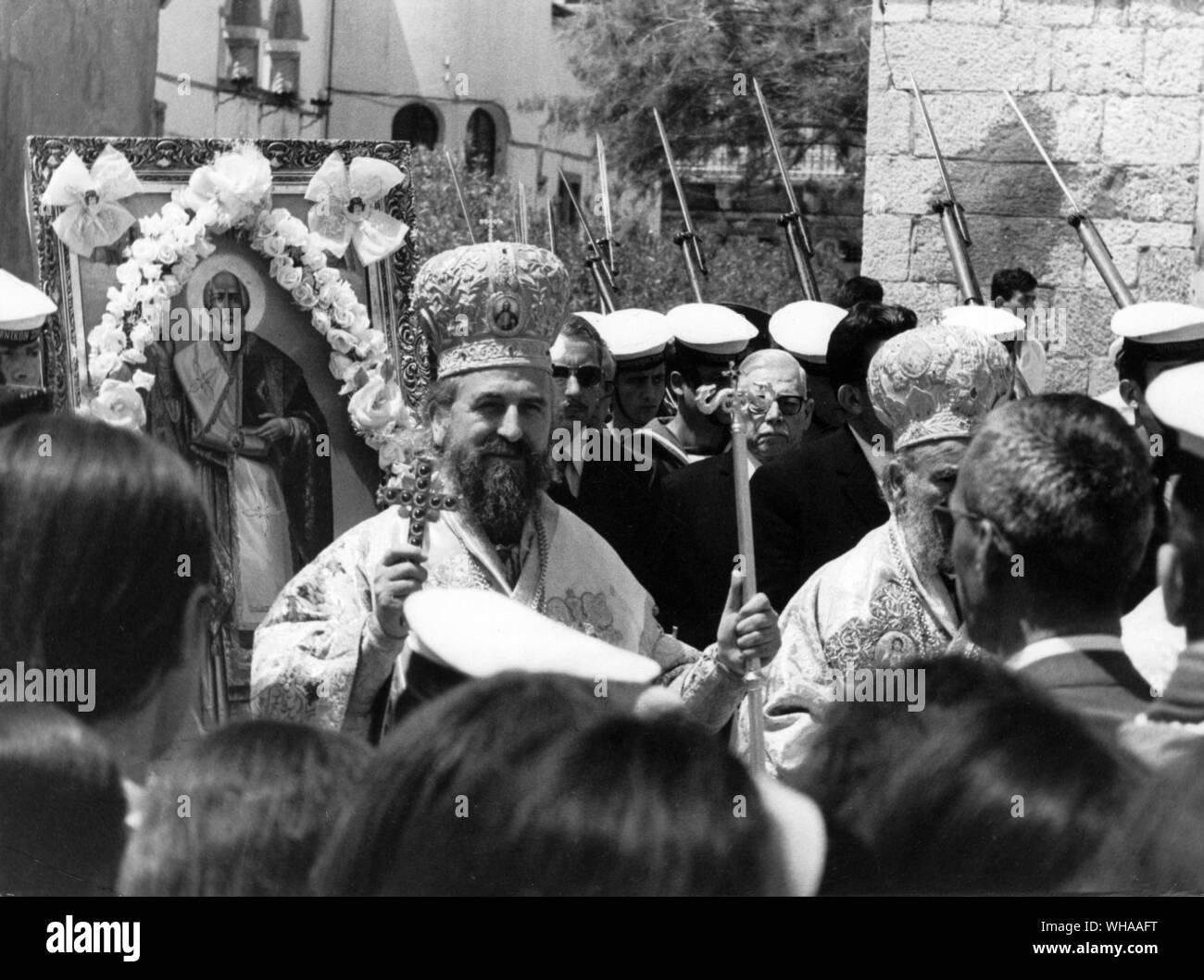 Island of Kalimnos Greece. Bishop of the Dodacannese Islands in parade through the town before blessing boats of sponge divers about to leave for diving on the North African Coast. May 1970 Stock Photo