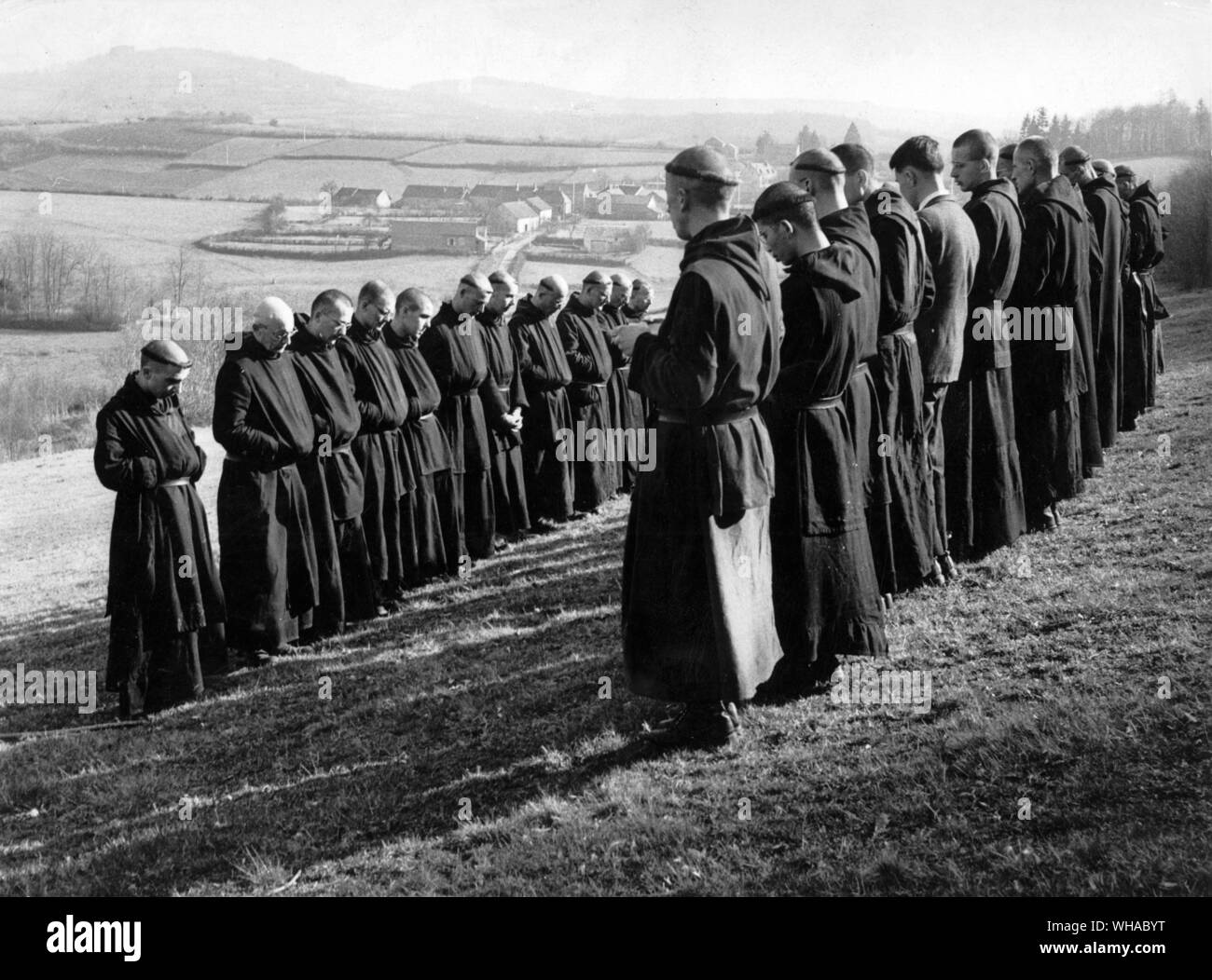 Benedictine monks pause in their work in the fields to pray Stock Photo