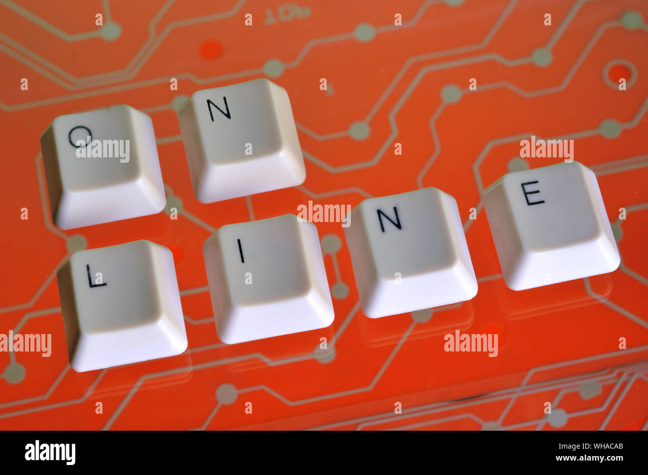 Keyboard keys form the word ON LINE on orange electric circuit in the background Stock Photo