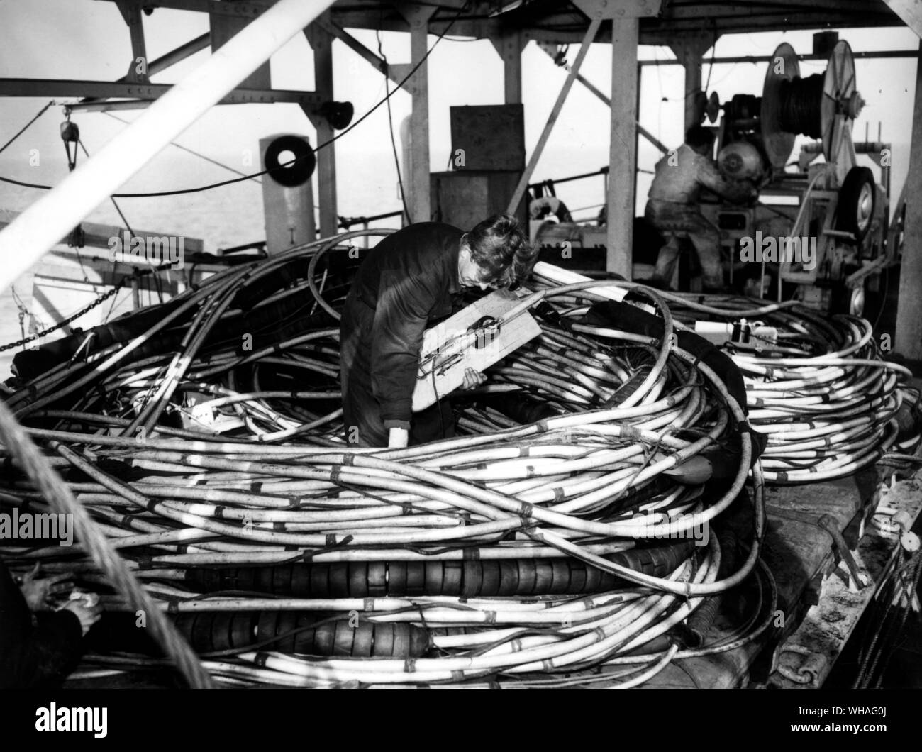 Floating cable with geophones mounted on paravanes stored on deck on completion of days operations during BP survey in Bournemouth Bay from the seismic ship Seislim. 1956 Stock Photo
