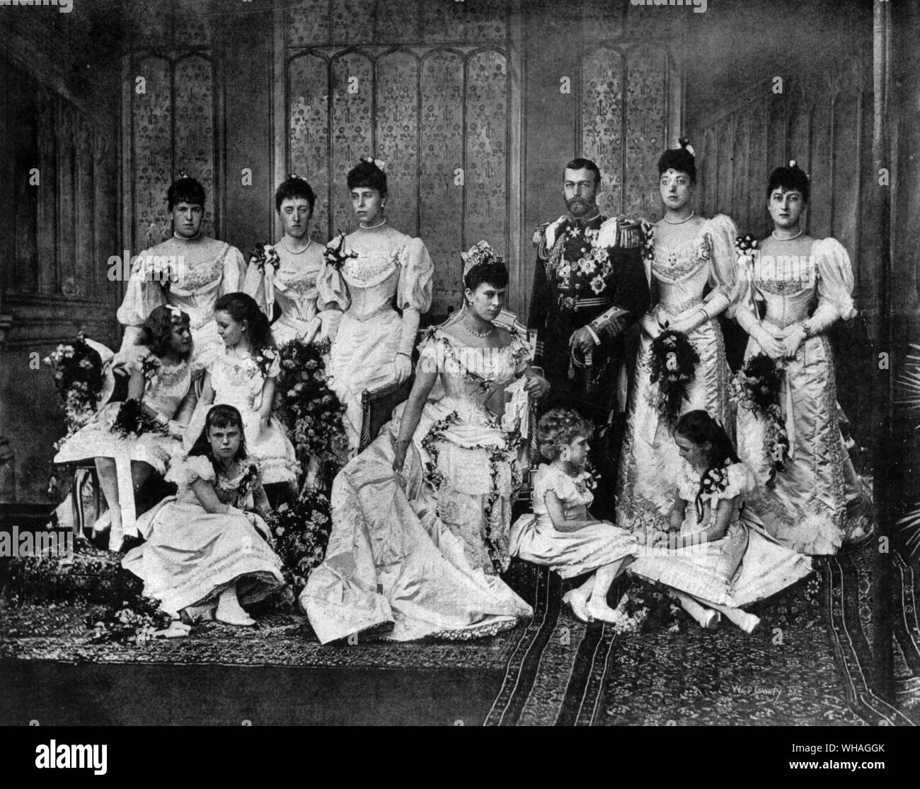 The Duke of York and his bride with the bridesmaids. Back row, left to right, Princess Alexander of Edinburgh, Princess Victoria of Schleswig-Holstein, Princess Victoria of Edinburgh, The Duke of York, Princess Victoria of Wales, Princess Maud of Wales. Middle row, Princess Alice of Battenberg, Princess Margaret of Connaught, The Duchess of york, . Front Row Princess Beatrice of Edinburgh, Princess Victoria of Battenberg, Princess Victoria Patricia of Connaught. Taken in Buckingham Palace on July 6th 1893. Future King George V and Queen Mary Stock Photo